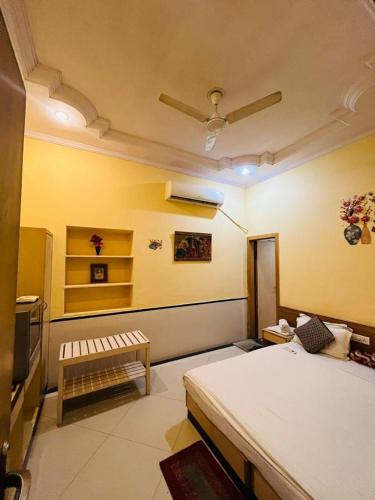 a bedroom with a bed and a bench in a room at Hotel Payal Jaisalmer in Jaisalmer