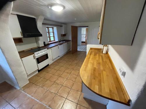 a kitchen with a wooden counter top in a room at korsholt-natur 135E in Sindal