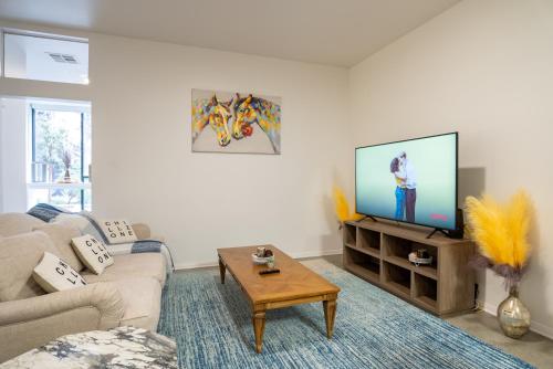 a living room with a couch and a flat screen tv at Cozy Huge LOFT for Live and Work in Los Angeles