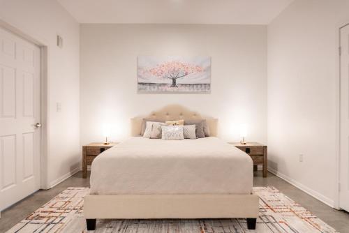 a white bedroom with a bed and two night stands at Cozy Huge LOFT for Live and Work in Los Angeles