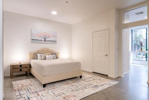 a white bedroom with a bed and a window at Cozy Huge LOFT for Live and Work in Los Angeles