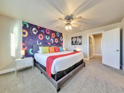 a bedroom with a large bed with a colorful headboard at Band Camp Town Home in Cedar City