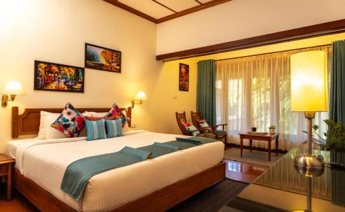 a bedroom with a large bed in a room at Backwater Ripples Kumarakom in Kumarakom