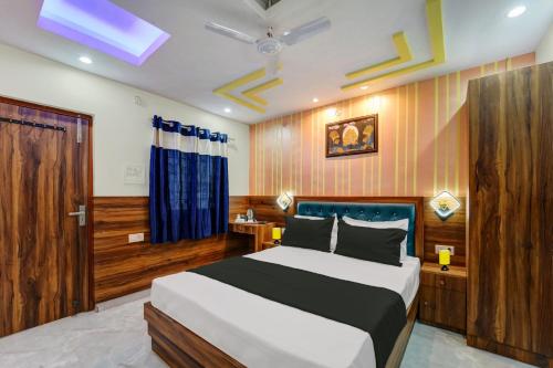 a bedroom with a large bed and a ceiling fan at Collection O Hotel Royal Sangrila in Patna