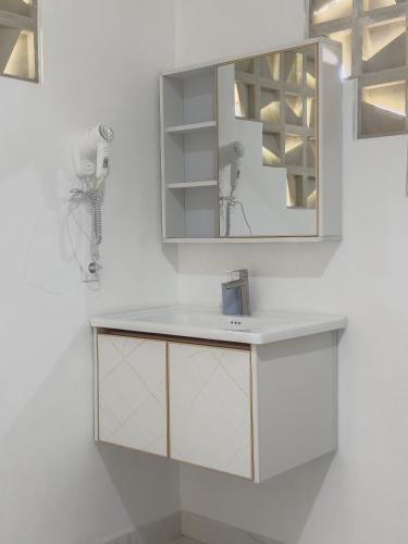 a bathroom with a sink and a mirror at Villa Senyum in Canggu