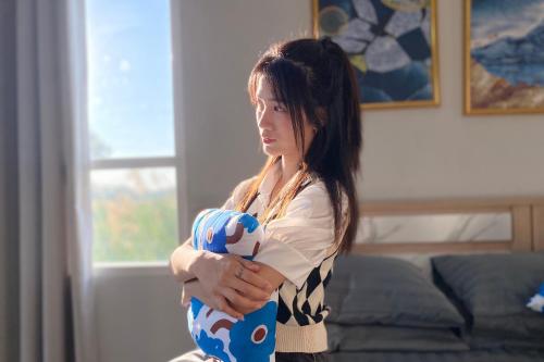 a young woman holding a stuffed animal in her arms at Grand Sansook Omnoi in Ban Khlong Om Noi