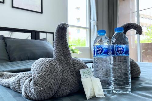 two stuffed animals sitting on a table with water bottles at Grand Sansook Omnoi in Ban Khlong Om Noi