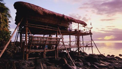 a building on the shore of the ocean at Bamboo house for Relaxation in Catbalogan
