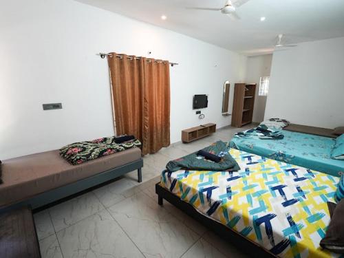 a room with two beds in a room at Silver springs Homestay Chickmagalur in Chikmagalūr