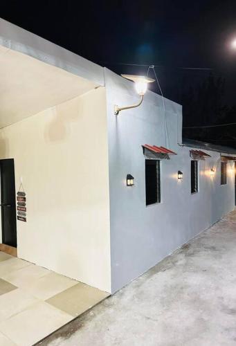 a white wall with lights on the side of a building at Transient House Camarines Sur Pili in Pili