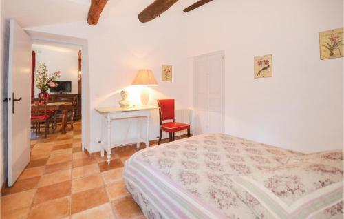 a bedroom with a bed and a desk and a table at Lovely Apartment In Les Salles-du-gardon With Kitchen in Soustelle