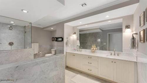 a bathroom with two sinks and a large mirror at Residence 703 At The Grand in Wildwood