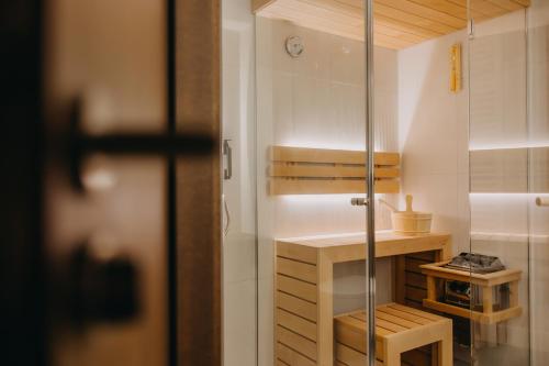 a small bathroom with a shower and a table at Elements Apartments in Świeradów-Zdrój