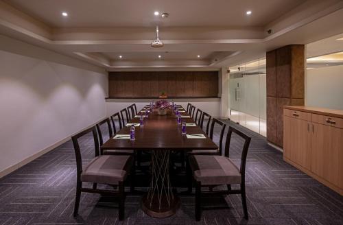 a long dining room with a long table and chairs at Hotel Saket 27 in New Delhi