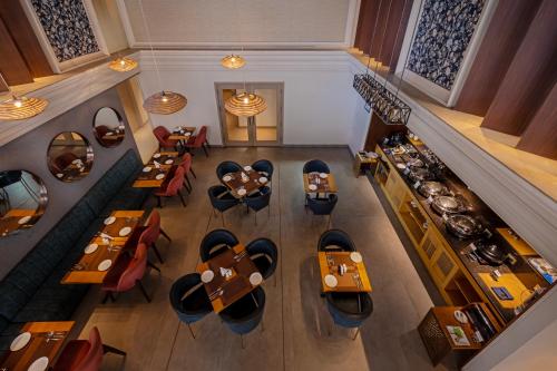an overhead view of a restaurant with tables and chairs at Hotel Saket 27 in New Delhi