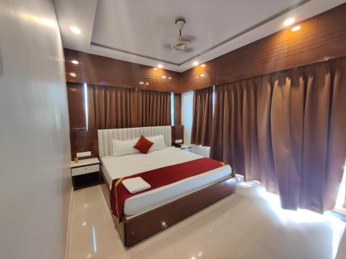 a bedroom with a large bed in a room at RIVA New Digha in Digha