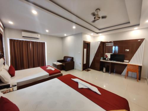 a hotel room with a bed and a desk at RIVA New Digha in Digha