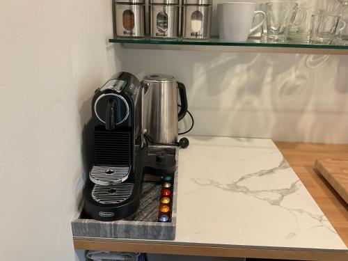 a coffee maker sitting on a counter in a kitchen at Dunedin Central Luxe Pad in Dunedin