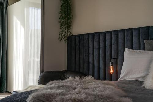 a bedroom with a bed with a black head board at Dunedin Central Luxe Pad in Dunedin
