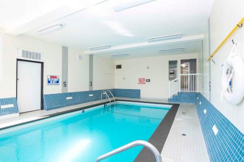 a large swimming pool with blue tiles on the walls at Sandman Hotel & Suites Prince George in Prince George
