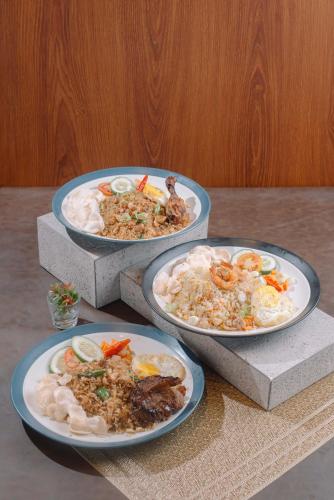 three plates of food sitting on a table at ARTOTEL Cabin Bromo in Bromo