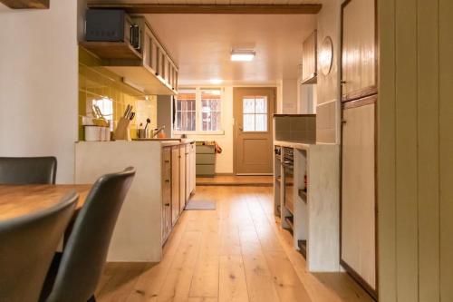 a kitchen with a wooden floor and a table at Lakeview Family Apartment in Ringgenberg