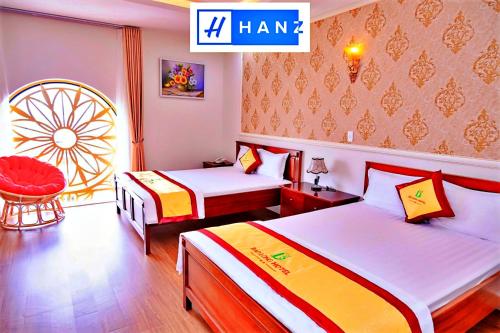 une chambre d'hôtel avec deux lits et une chaise dans l'établissement Bao Long Hotel, à Hô-Chi-Minh-Ville
