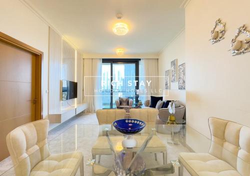 a living room with a glass table and chairs at Superb 1BR at Burj Vista In Downtown Dubai in Dubai