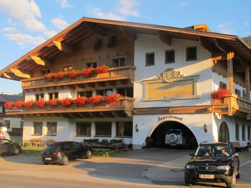 a large building with cars parked in front of it at Appartement Schörghofer in Filzmoos