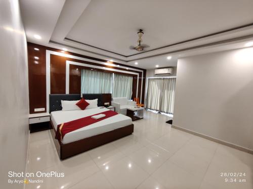 a bedroom with a bed with a red blanket at RIVA New Digha in Digha