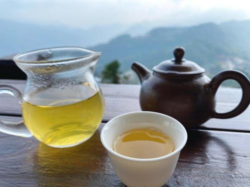 a cup of tea and a teapot on a table at Siangting B&B in Fenchihu