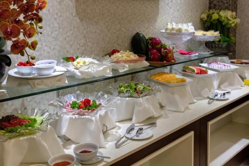 a buffet with many plates of food on a table at Skylark Boutique Hotel in Hanoi
