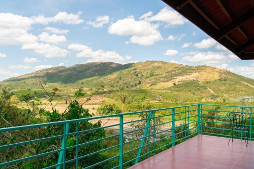 a balcony with a view of a mountain at Ivory Falls Villa in Di Linh