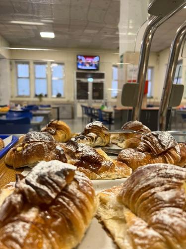 a bunch of different types of pastries on a table at Foresteria Roma Esercito della Salvezza in Rome