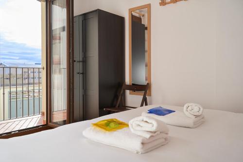 a room with towels on a bed with a balcony at CASA GALEX in Sarrión