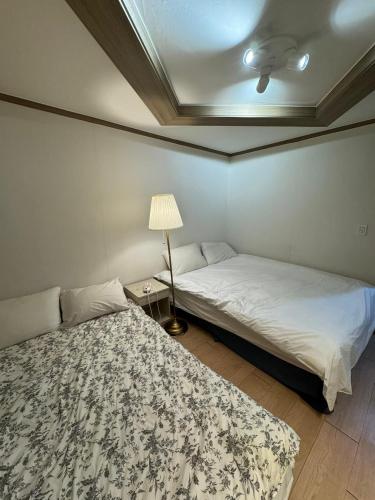 Ένα ή περισσότερα κρεβάτια σε δωμάτιο στο G Mini Hotel Dongdaemun