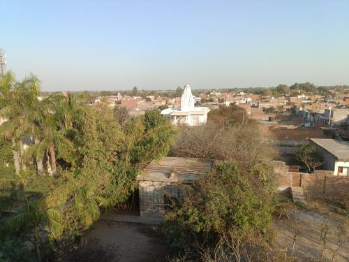 a view of a city with a white building at Divine palace in Vrindāvan