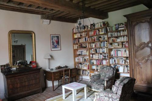 a living room with a book shelf filled with books at Maison de Noble Nicolas in Avallon