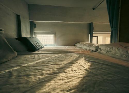 a large bed in a room with a window at Amouter HC in Hengchun