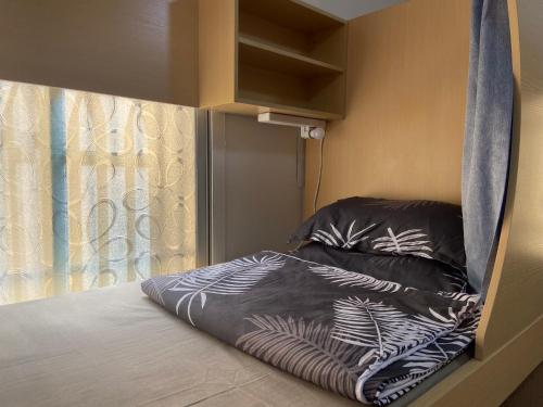 a small bed in a room with a window at Loong shared book on web in Riyadh