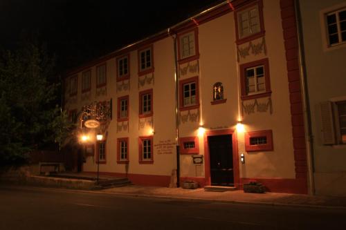 a building with a clock on the side of a street at Hotel Zum Goldenen Anker in Bamberg
