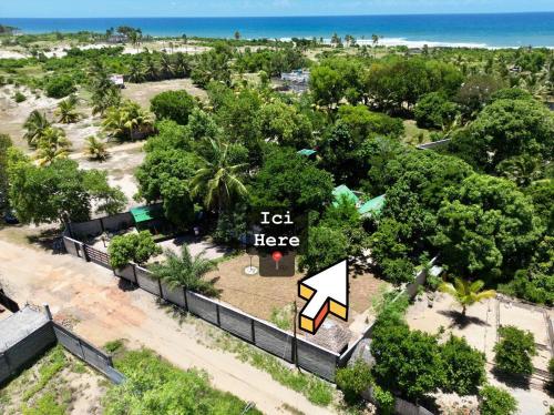 an aerial view of a beach with a sign that says left here at Le Jardin Arhumatic in Sambava
