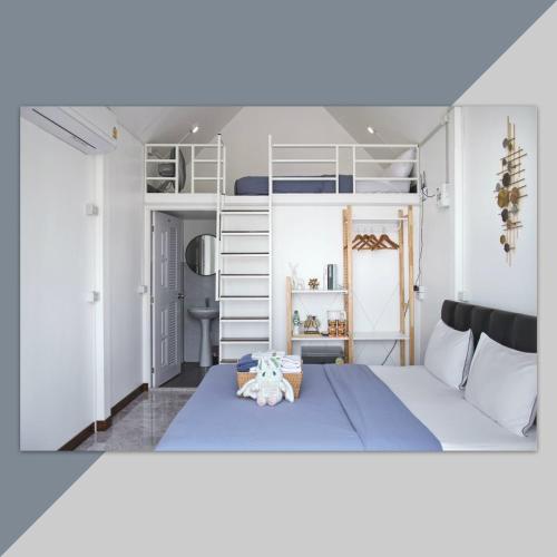 a bedroom with a blue bed and white bunk beds at วันทน่า โฮมสเตย์ บ้านมุง เนินมะปราง in Ban Mung