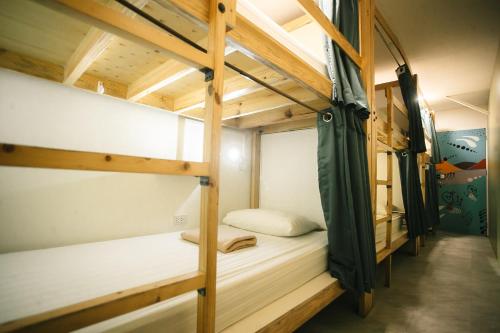 a room with bunk beds in a hostel at Murals Hostel and Cafe in Cebu City