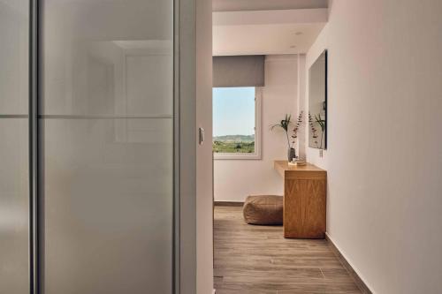 a hallway with a glass door leading into a room at Sun Villa View in Lithakia