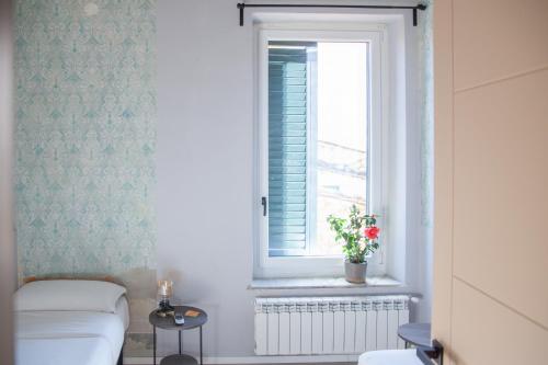 a bathroom with a toilet and a window at Aretium in Arezzo