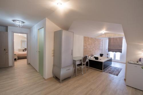 a room with a desk and a room with a bed at SUITES PIROFANI in Lefkada Town
