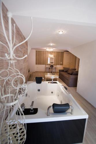 a kitchen and living room with a bath tub at SUITES PIROFANI in Lefkada