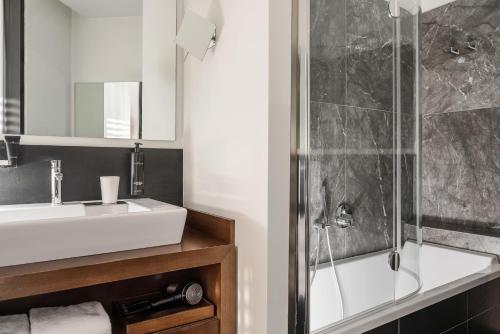 a bathroom with a sink and a shower at Welcome Hotel in San Marino