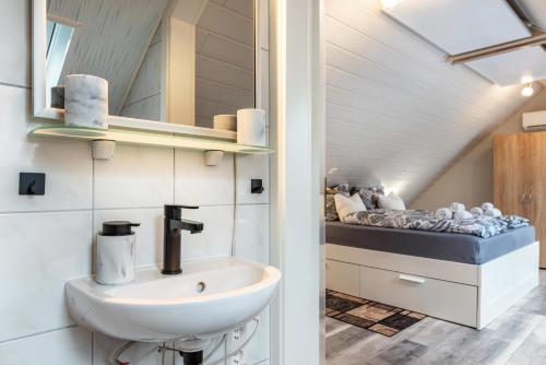 a bathroom with a sink and a bed at Opitz in Allensbach